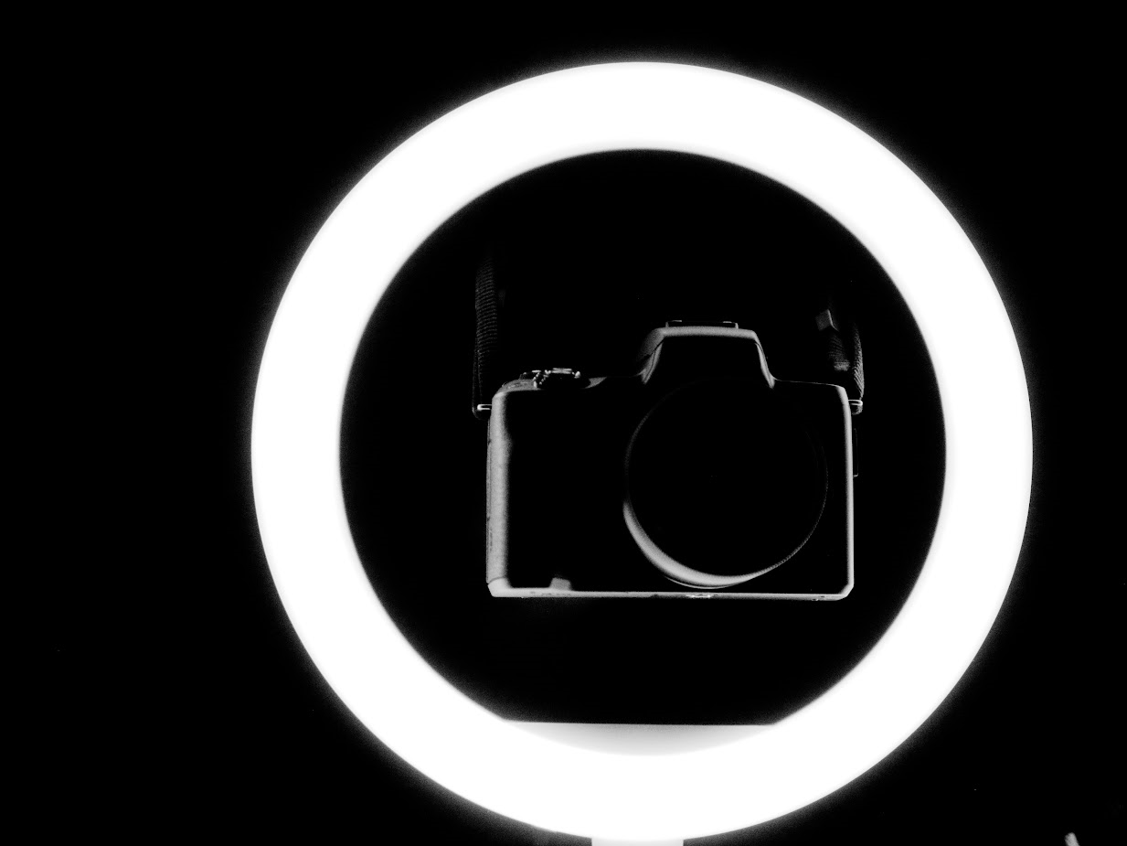 Black and white photo of a camera on a black background