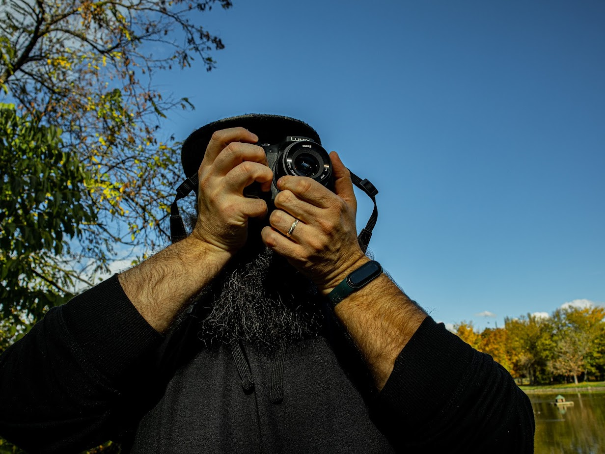 Photo of a man holding a camera