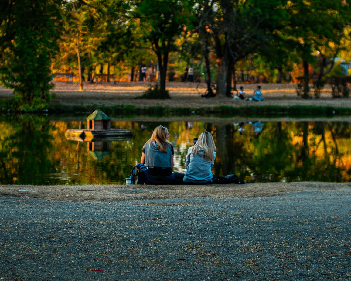 Photo of two women by a small lake
